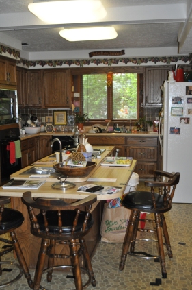 BEFORE--Another view of the kitchen from the island. The cabinet color is pure '70's. The old bar stools are perfect.