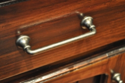 The new pulls are simple and complement the antiqued cabinet finish, creating a clean look.
